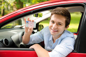 Teen driver in Florida holding and showing his drivers license 